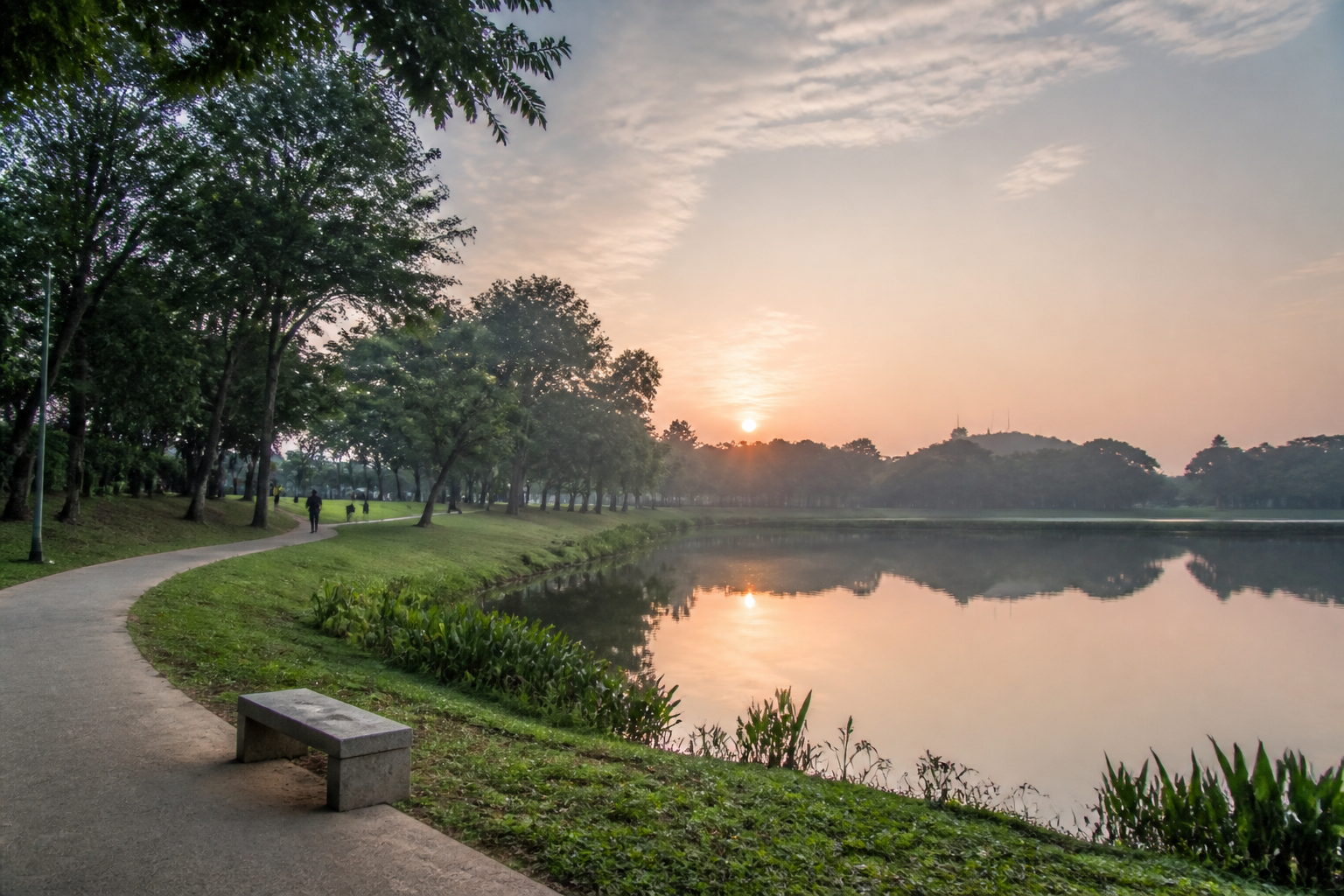 Morning path beside a reflective lake in Setia Alam